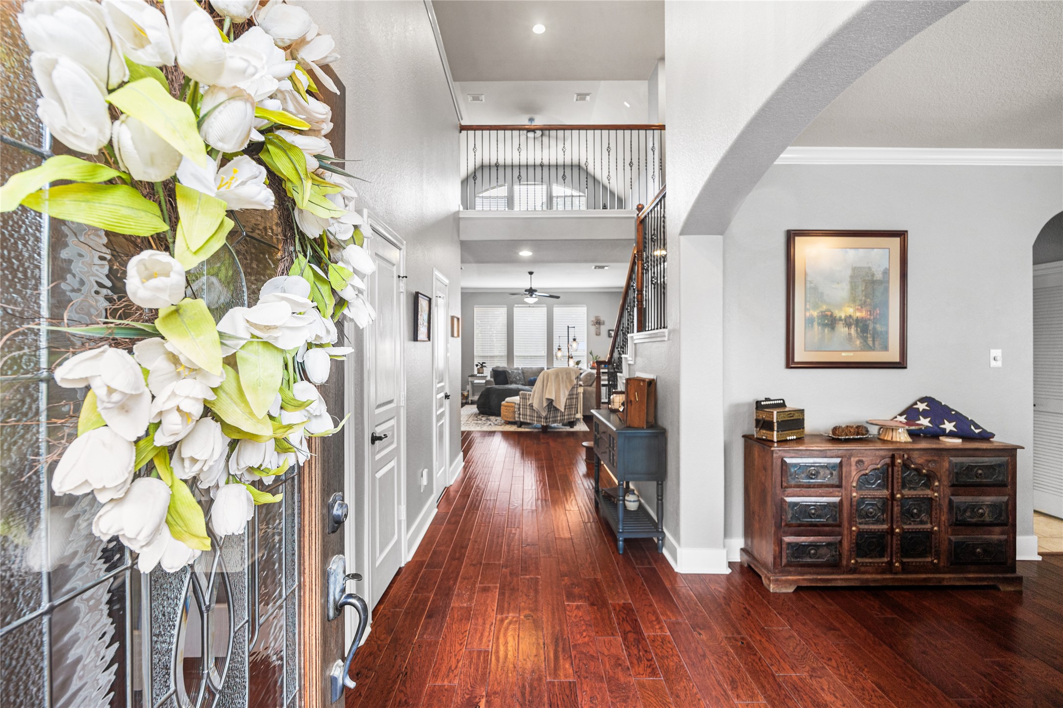 2167 Summit Mist Drive Conroe, TX 77304 - Photo 5 of 34 a view of a hallway with wooden floor windows and a chandelier