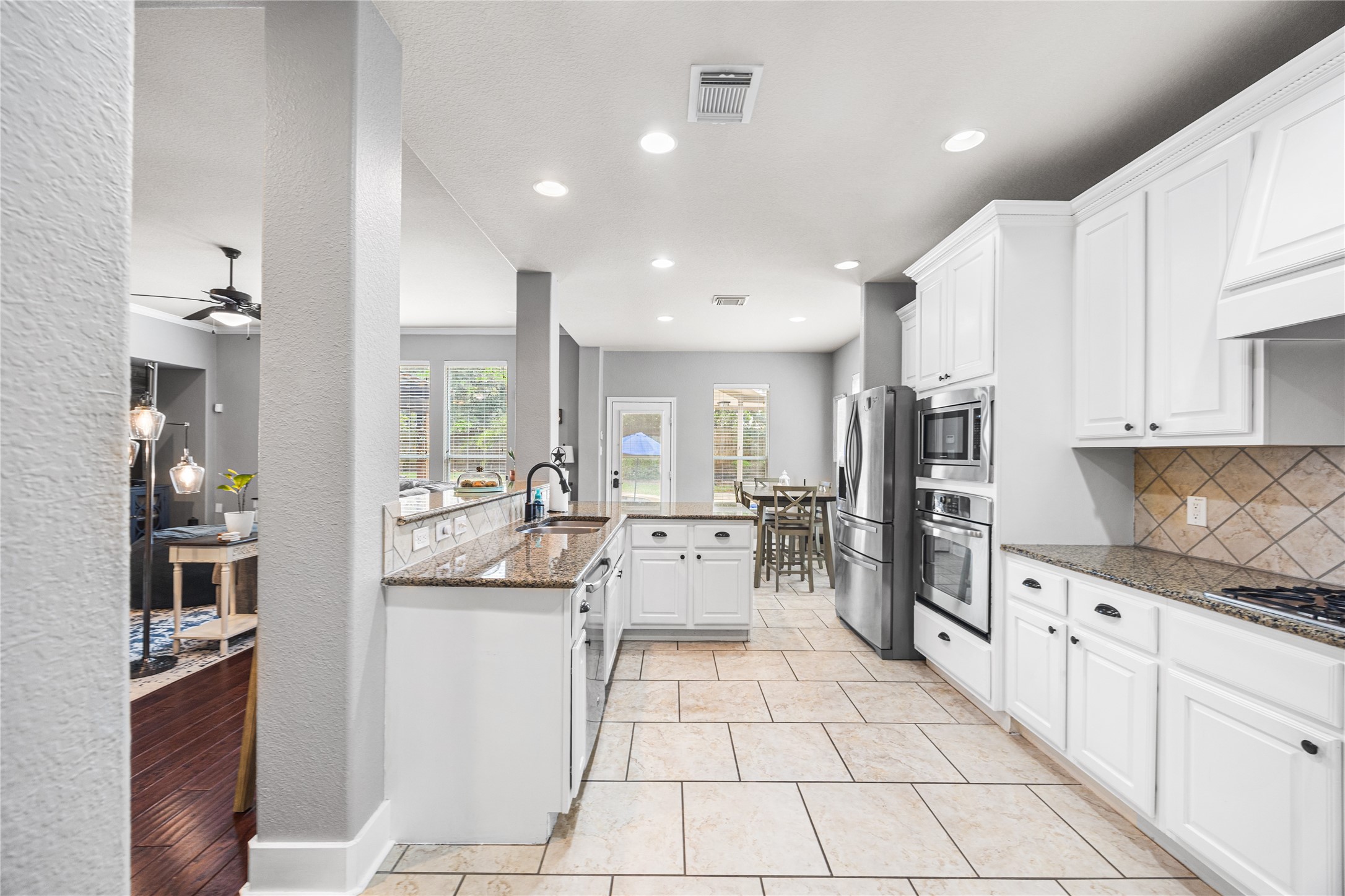 2167 Summit Mist Drive Conroe, TX 77304 - Photo 9 of 34 a kitchen with white cabinets and appliances