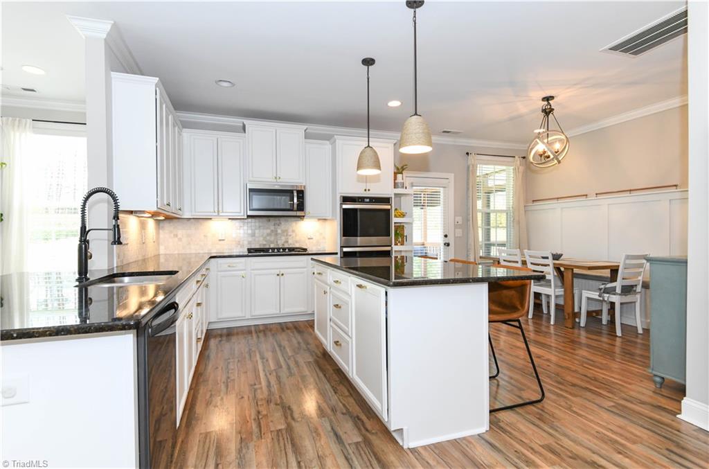 7729 Carson Path Summerfield, NC 27358 - Photo 5 of 48 counter seating at bar. Extra big island!