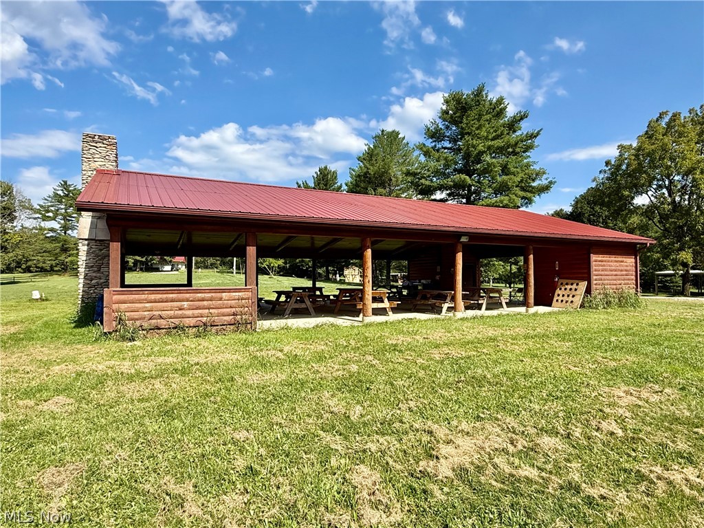 79601 Adams Road Freeport, OH 43973 - Photo 20 of 49 Main Amish-made log pavilion with stone fireplace, electric outlets, bathroom and storage room