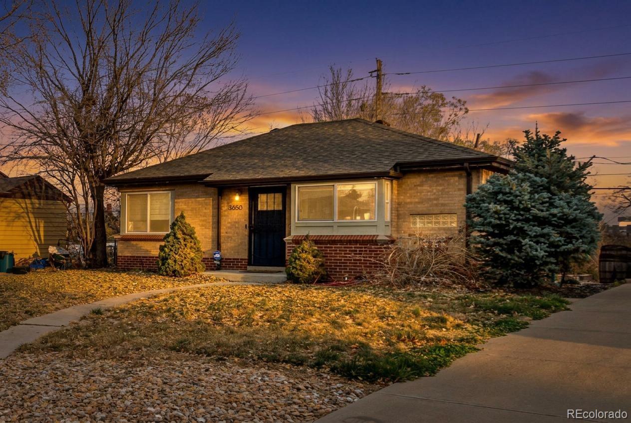 3650 Oneida Street Denver, CO 80207 - Photo 1 of 31 a front view of a house with a yard