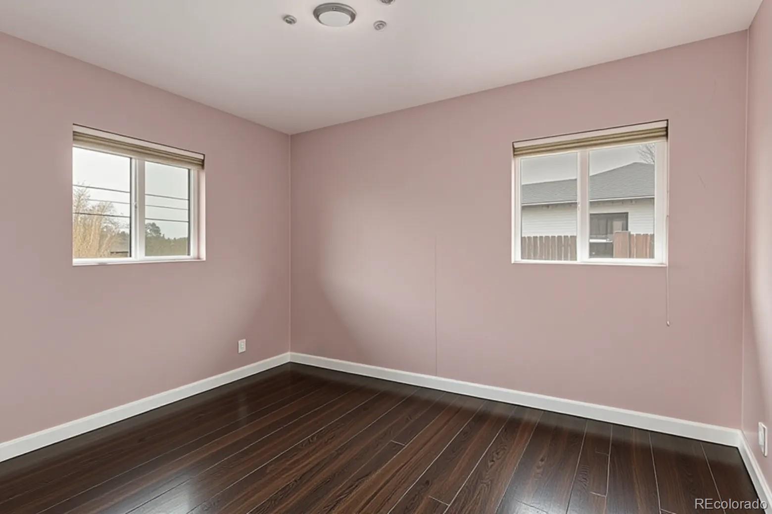3650 Oneida Street Denver, CO 80207 - Photo 12 of 31 a view of an empty room with wooden floor and a window
