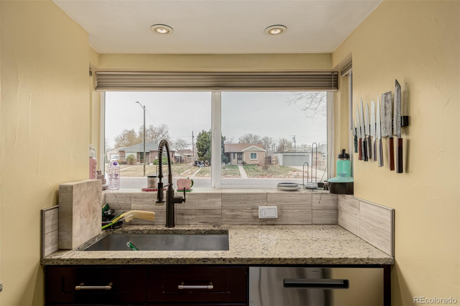 3650 Oneida Street Denver, CO 80207 - Photo 13 of 28 a kitchen with a sink and a window