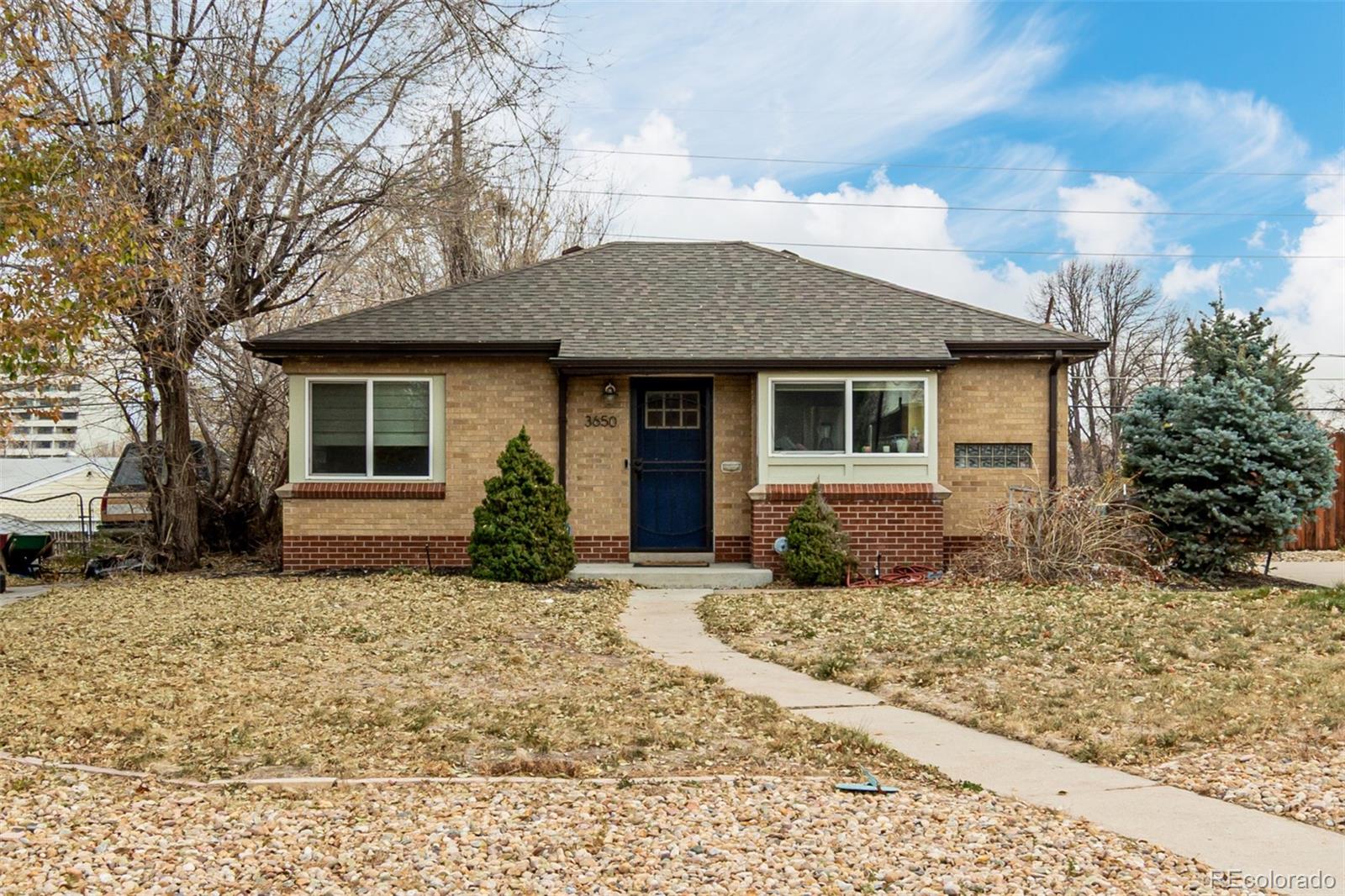 3650 Oneida Street Denver, CO 80207 - Photo 2 of 28 a front view of a house with a yard