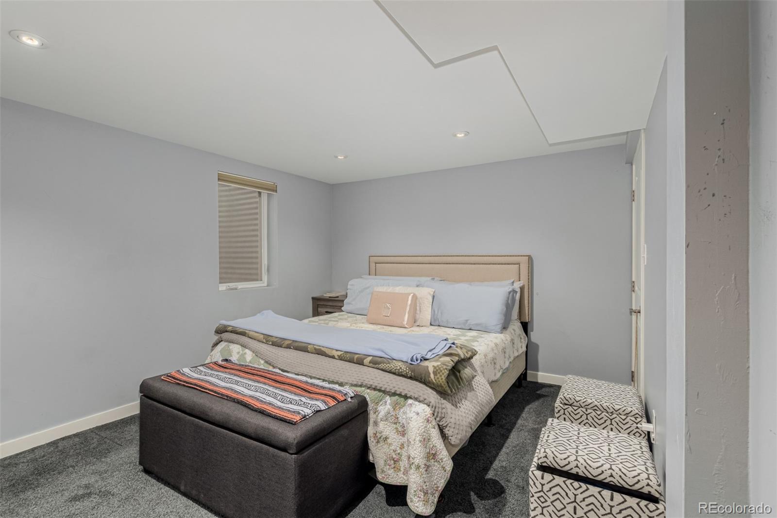 3650 Oneida Street Denver, CO 80207 - Photo 21 of 28 a bedroom with a bed and a window