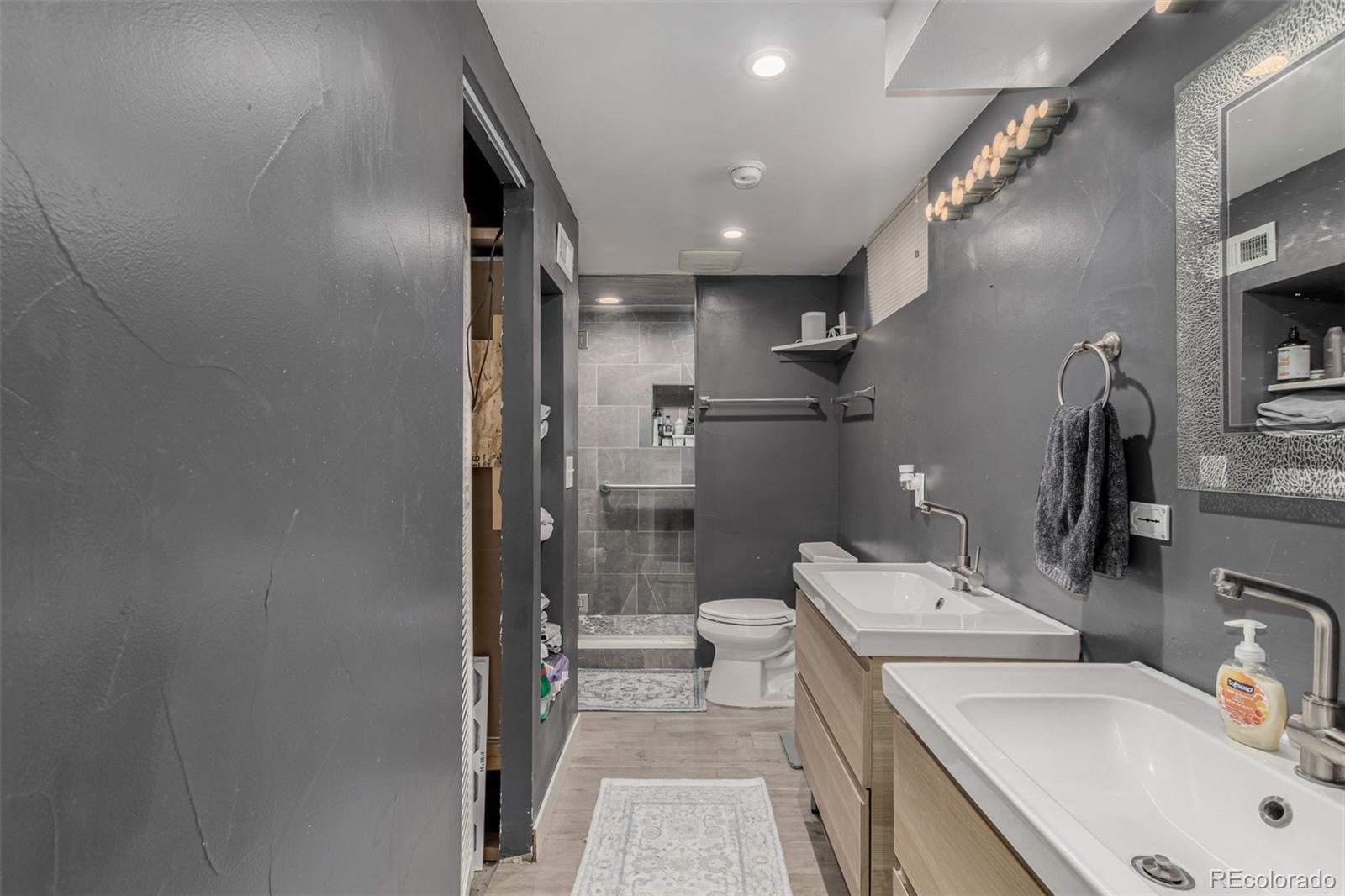 3650 Oneida Street Denver, CO 80207 - Photo 23 of 28 a bathroom with a sink toilet and shower