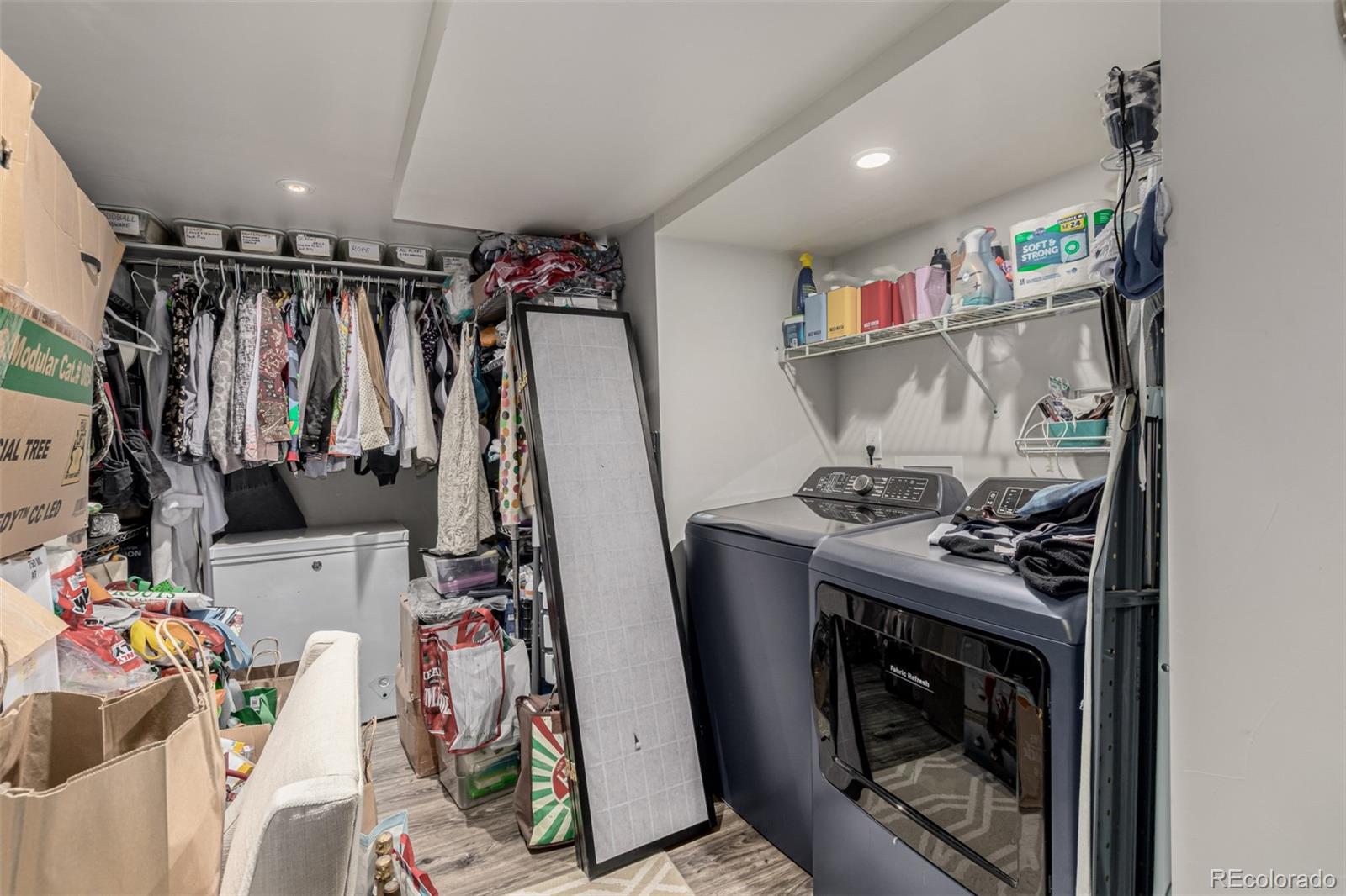 3650 Oneida Street Denver, CO 80207 - Photo 24 of 28 a view of walk in closet with clothes and shoes