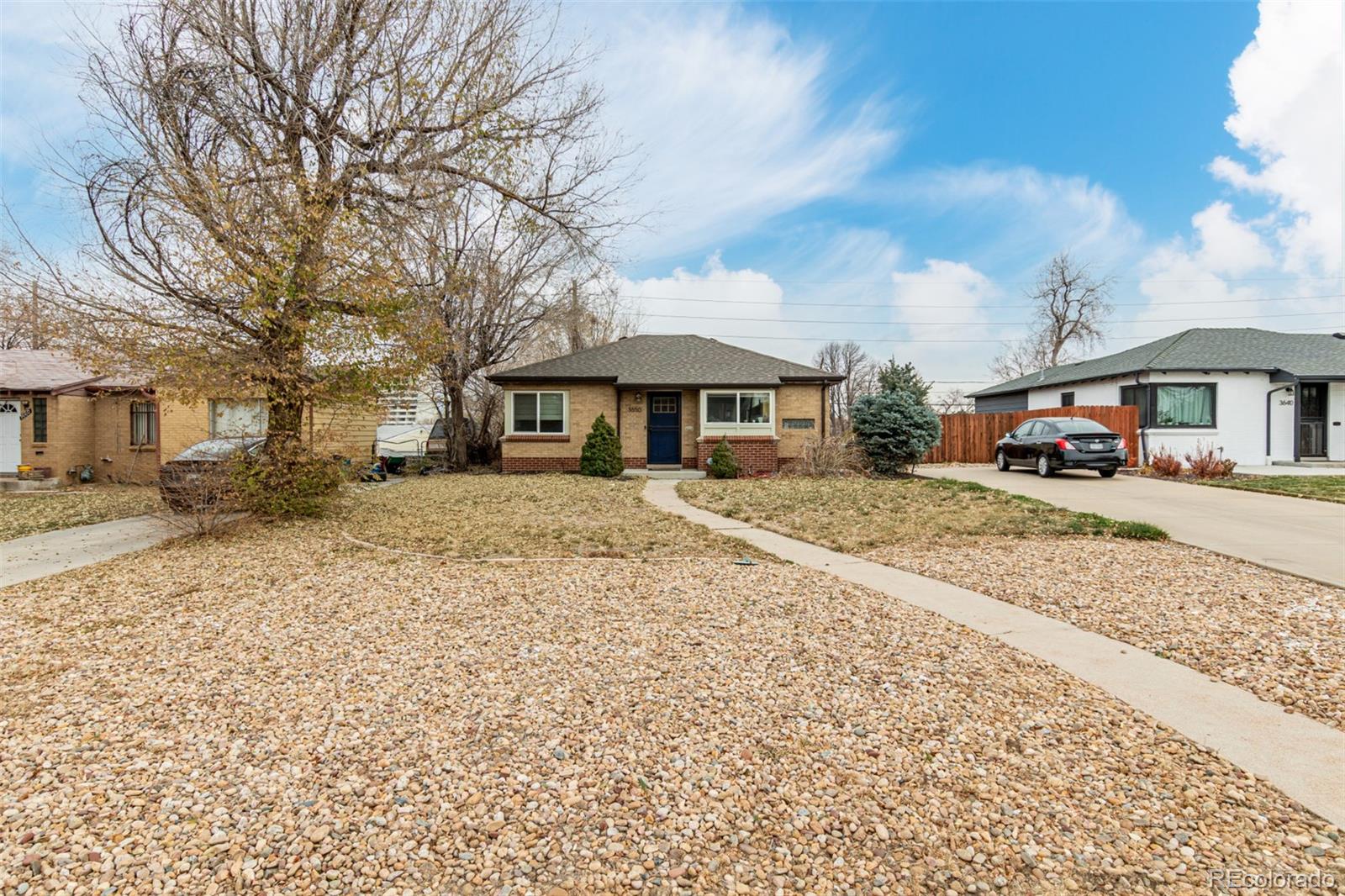3650 Oneida Street Denver, CO 80207 - Photo 3 of 28 a front view of a house with a yard