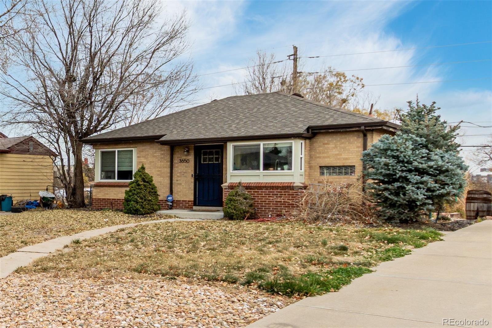 3650 Oneida Street Denver, CO 80207 - Photo 4 of 28 a front view of a house with a yard and glass windows