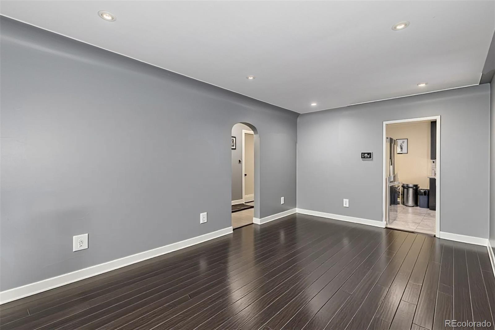 3650 Oneida Street Denver, CO 80207 - Photo 4 of 31 a view of an empty room with wooden floor