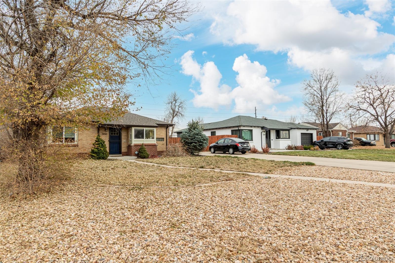 3650 Oneida Street Denver, CO 80207 - Photo 7 of 28 a front view of a house with a yard and trees