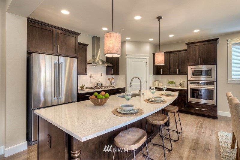 1438 241st Place Southeast Bothell, WA 98021 - Photo 3 of 19 a kitchen with refrigerator and chairs
