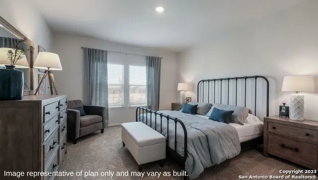 a bedroom with furniture and a window