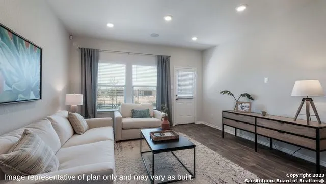 a living room with furniture and a window