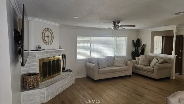 a living room with furniture a fireplace and a large window