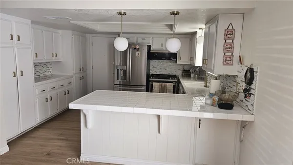a kitchen with cabinets and window