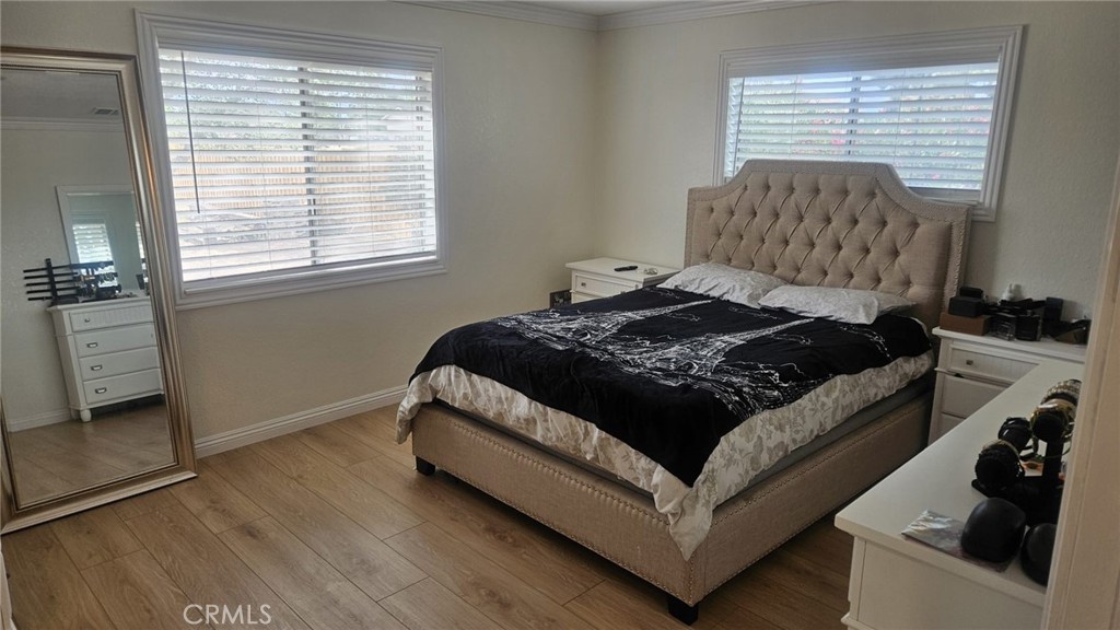 10671 Pinon Avenue Hesperia, CA 92345 - Photo 4 of 13 a living room with a bed furniture and a window