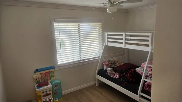 a room with a window and a ceiling fan