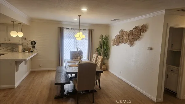 a view of a dining room with furniture and a wooden floor