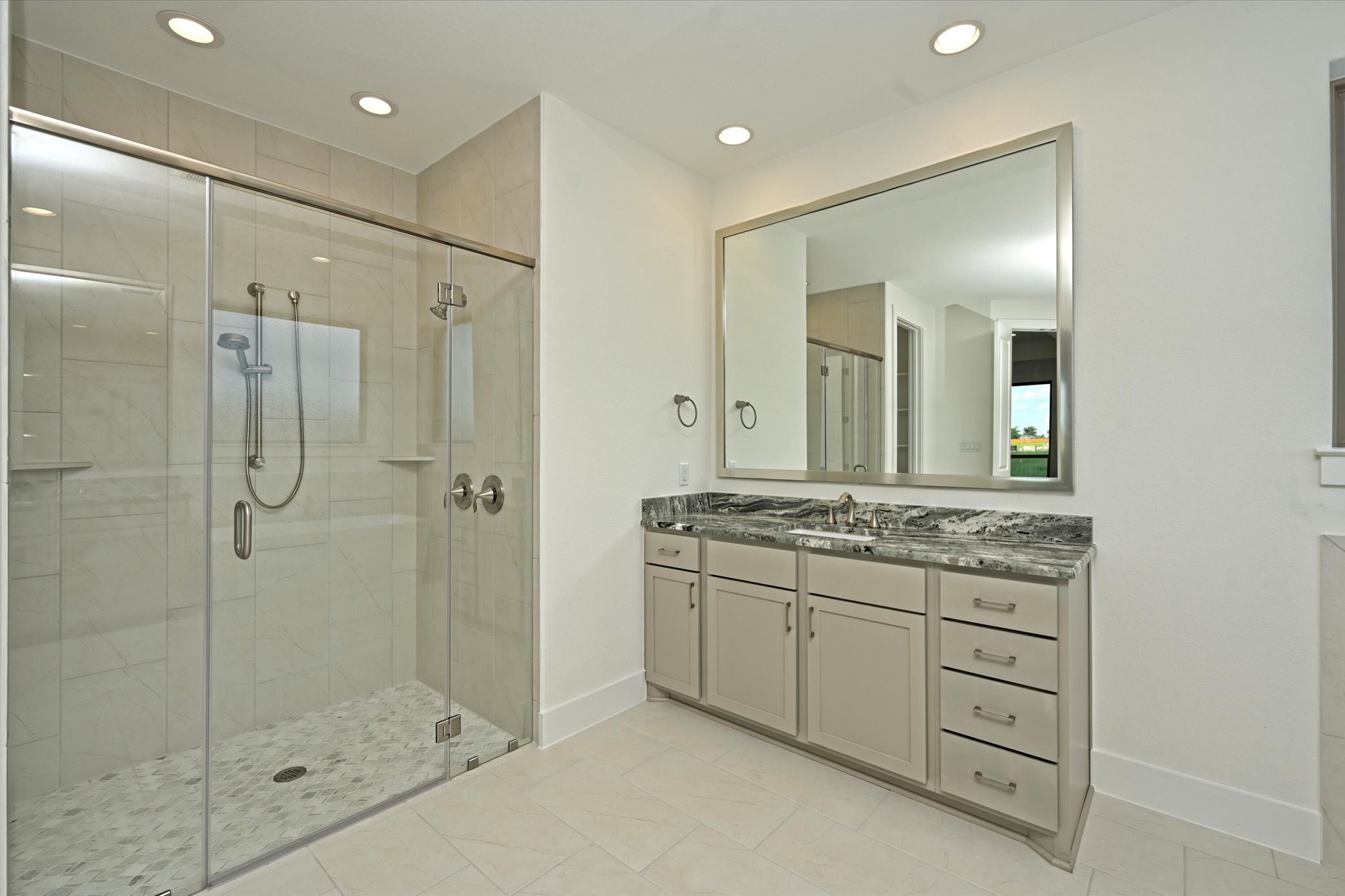 209 Scofield Avenue Georgetown, TX 78626 - Photo 21 of 33 a bathroom with a granite countertop sink a mirror and a shower