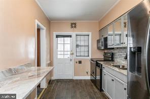 1618 Roundhill Road Baltimore, MD 21218 - Photo 15 of 50 a kitchen with a sink stove top oven and refrigerator