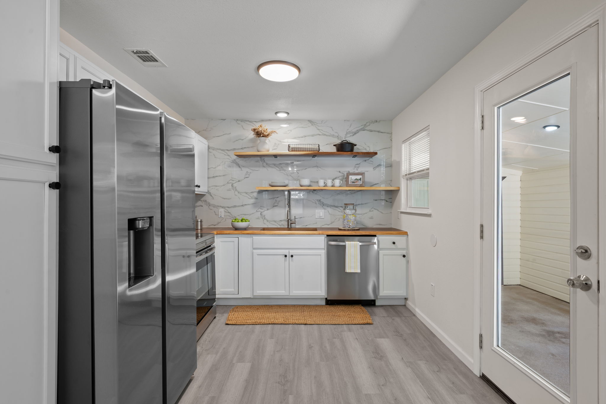 4711 Bandera Road Austin, TX 78721 - Photo 3 of 22 a kitchen with stainless steel appliances granite countertop a refrigerator and a sink