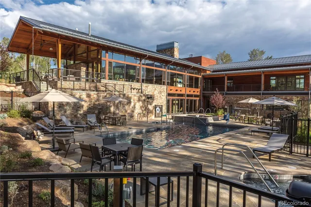 a kitchen with a stove a refrigerator and wooden floor