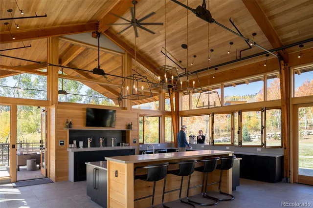 a room with gym equipment and large windows