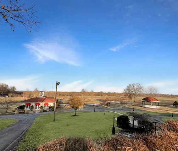 a kitchen with stainless steel appliances kitchen island granite countertop a table chairs in it