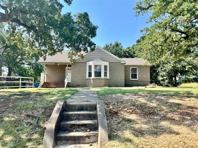 a front view of house with yard and green space