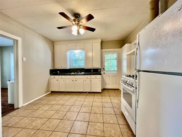 a kitchen with stainless steel appliances a refrigerator and a stove top oven