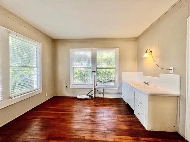 a room with wooden floors and pool