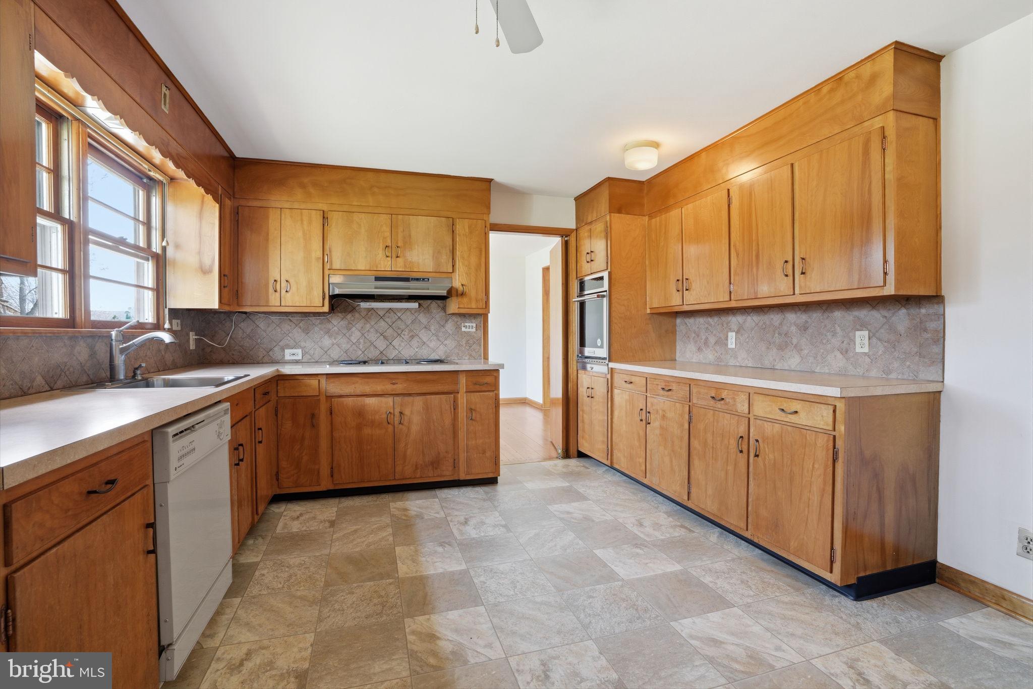 10 Home Road Hatboro, PA 19040 - Photo 13 of 42 a kitchen with granite countertop a stove a sink a window and counter space