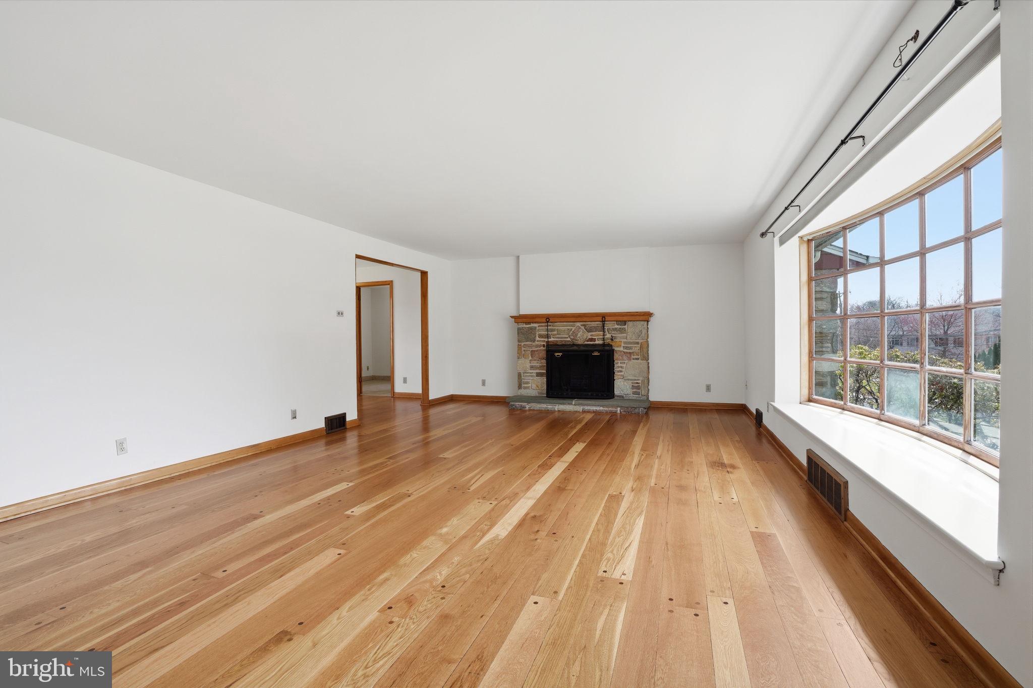 10 Home Road Hatboro, PA 19040 - Photo 8 of 42 a view of empty room with a fireplace and wooden floor