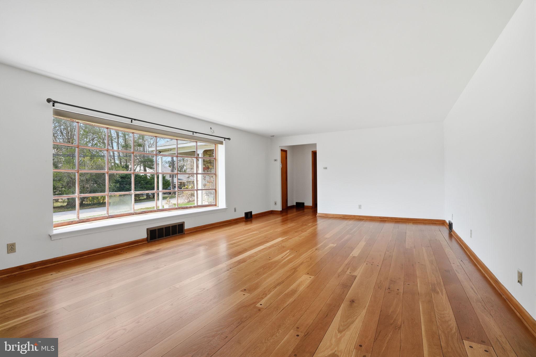 10 Home Road Hatboro, PA 19040 - Photo 9 of 42 a view of an empty room with wooden floor and a window