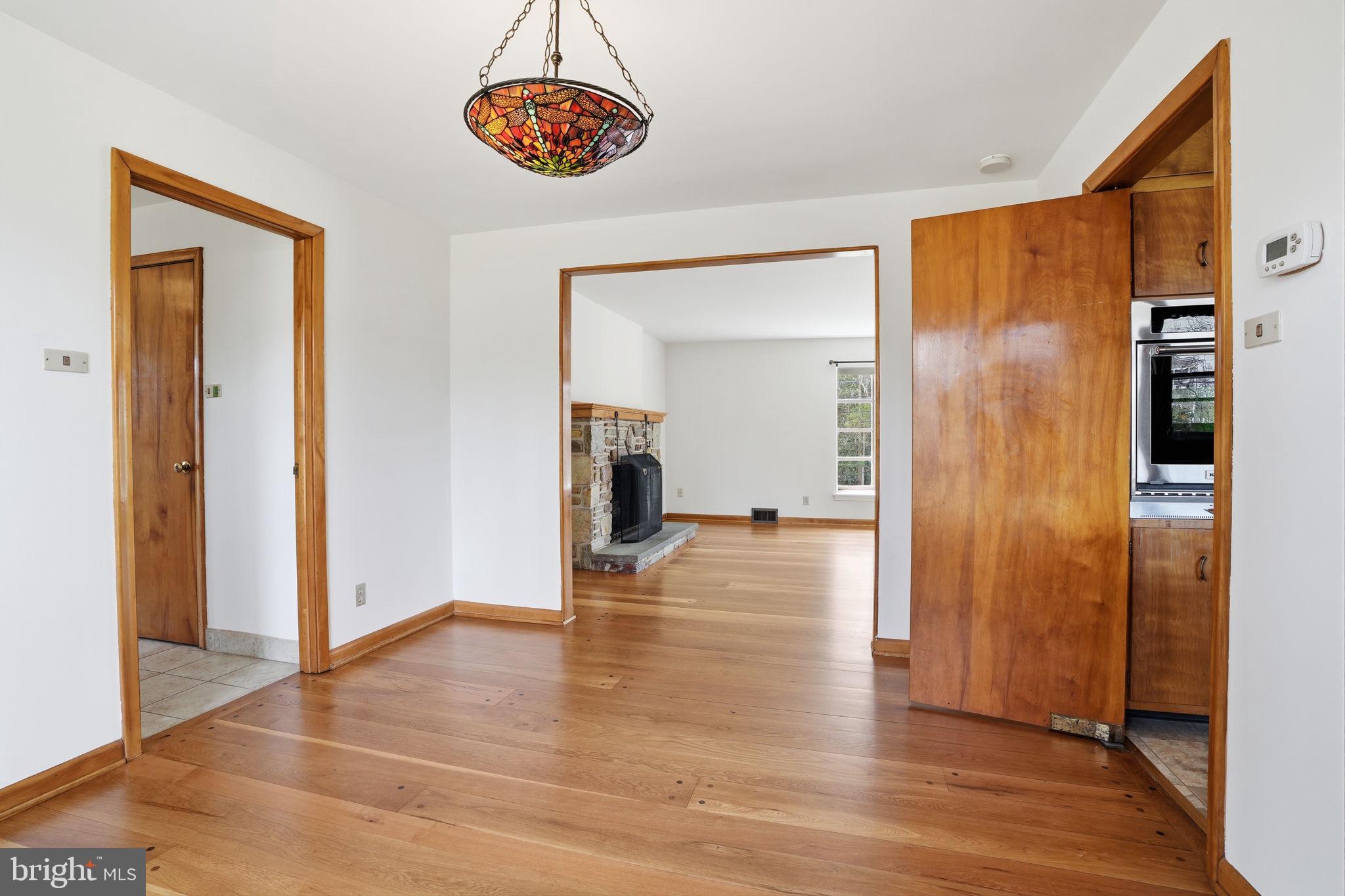 10 Home Road Hatboro, PA 19040 - Photo 10 of 42 a view of a hallway with wooden floor and dining room