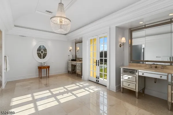 a spacious bathroom with a sink a large mirror and a shower