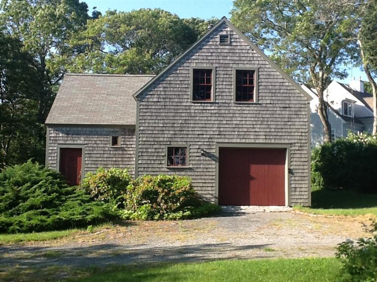 80 Old Dam Road Bourne, MA 02532 - Photo 17 of 31 a front view of a house with a yard and garage