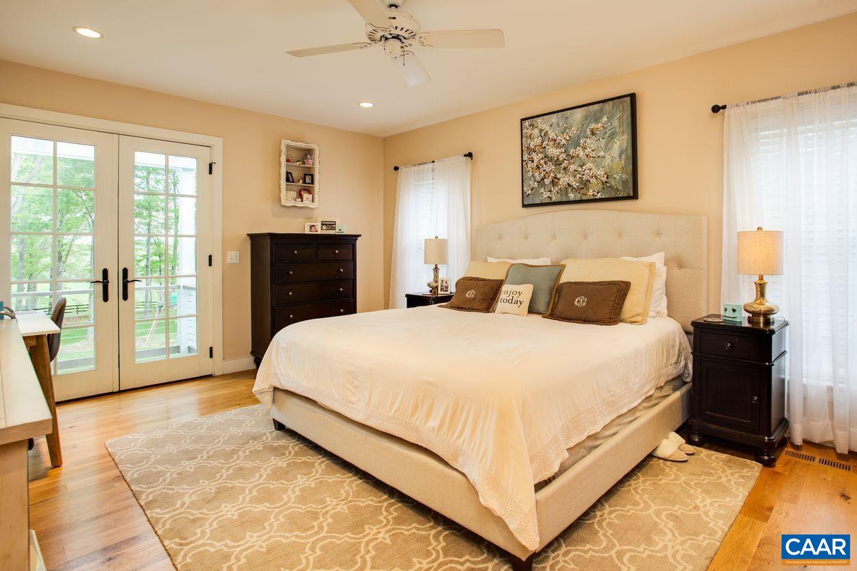 3923 Free Union Road Charlottesville, VA 22901 - Photo 25 of 52 a bedroom with a large bed and a tv