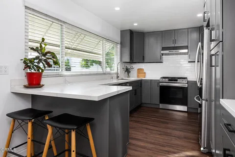 a kitchen with a stove a sink and a refrigerator