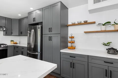a kitchen with a refrigerator and a sink