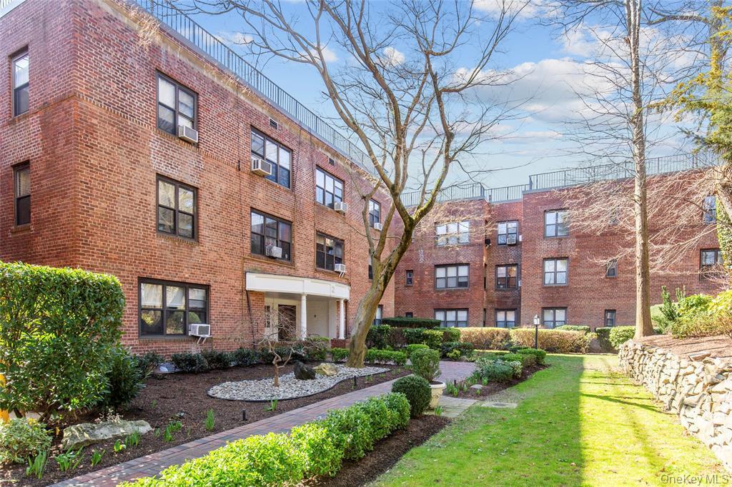 2 Town House Place, Unit 3N Great Neck, NY 11021 - Photo 1 of 26 a front view of a building with garden