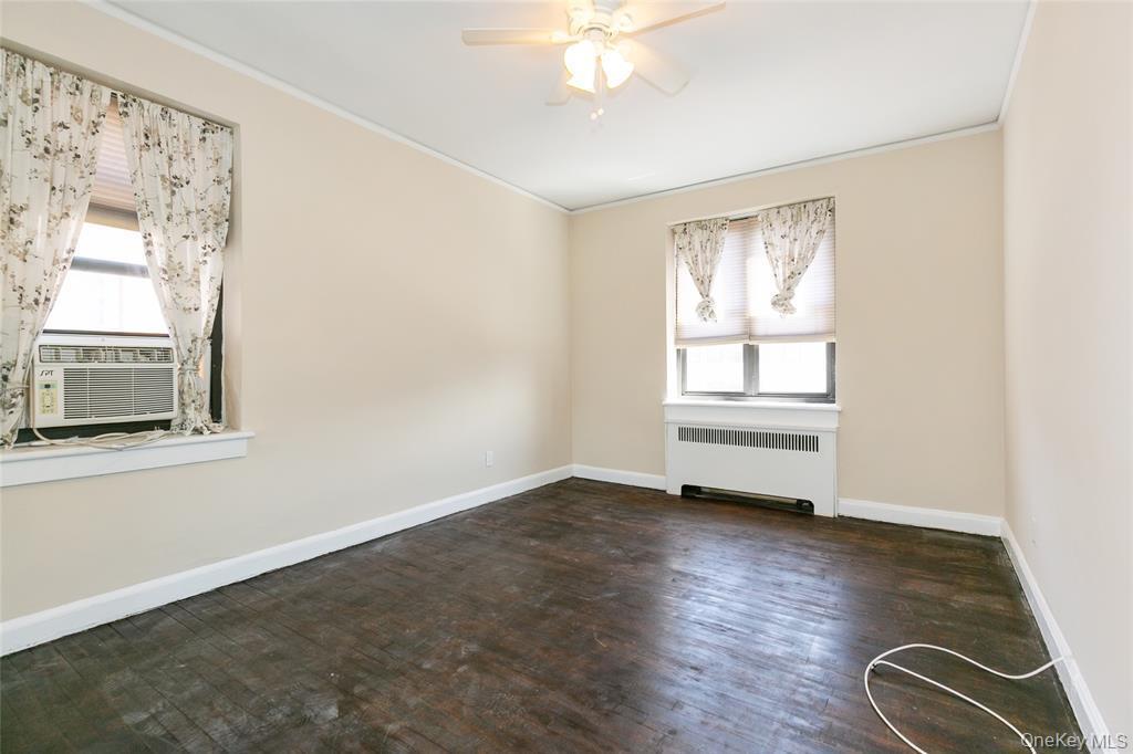 2 Town House Place, Unit 3N Great Neck, NY 11021 - Photo 13 of 26 a view of an empty room with a window and wooden floor