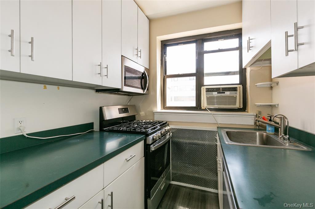 2 Town House Place, Unit 3N Great Neck, NY 11021 - Photo 18 of 26 a kitchen with granite countertop stainless steel appliances a sink stove and cabinets