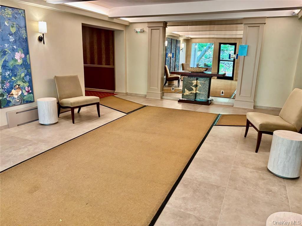 2 Town House Place, Unit 3N Great Neck, NY 11021 - Photo 21 of 26 a living room with furniture and a large window