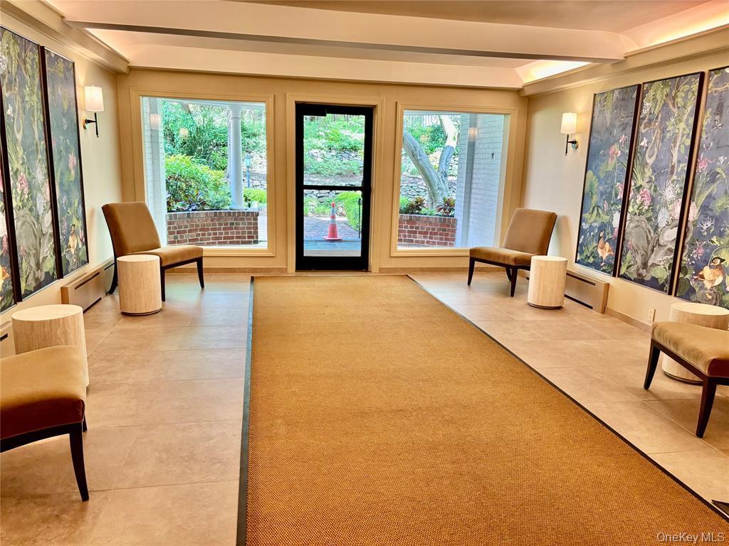 2 Town House Place, Unit 3N Great Neck, NY 11021 - Photo 4 of 26 a living room with furniture and a large window