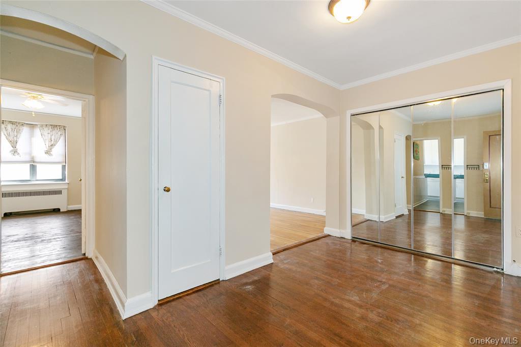 2 Town House Place, Unit 3N Great Neck, NY 11021 - Photo 5 of 26 an empty room with wooden floor and windows