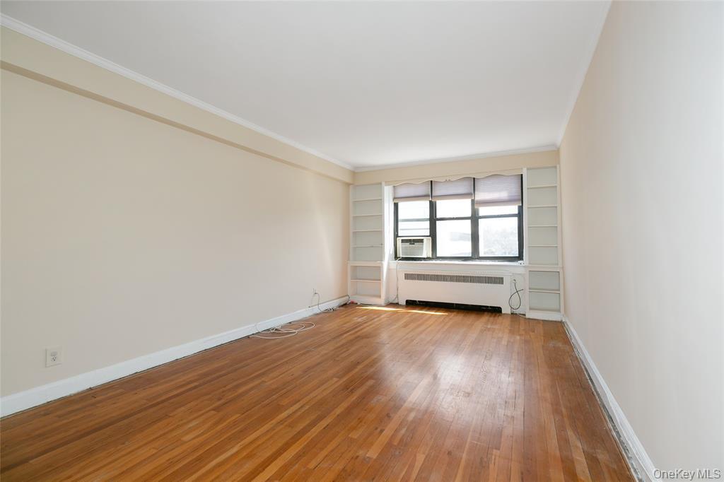 2 Town House Place, Unit 3N Great Neck, NY 11021 - Photo 10 of 26 an empty room with wooden floor and windows