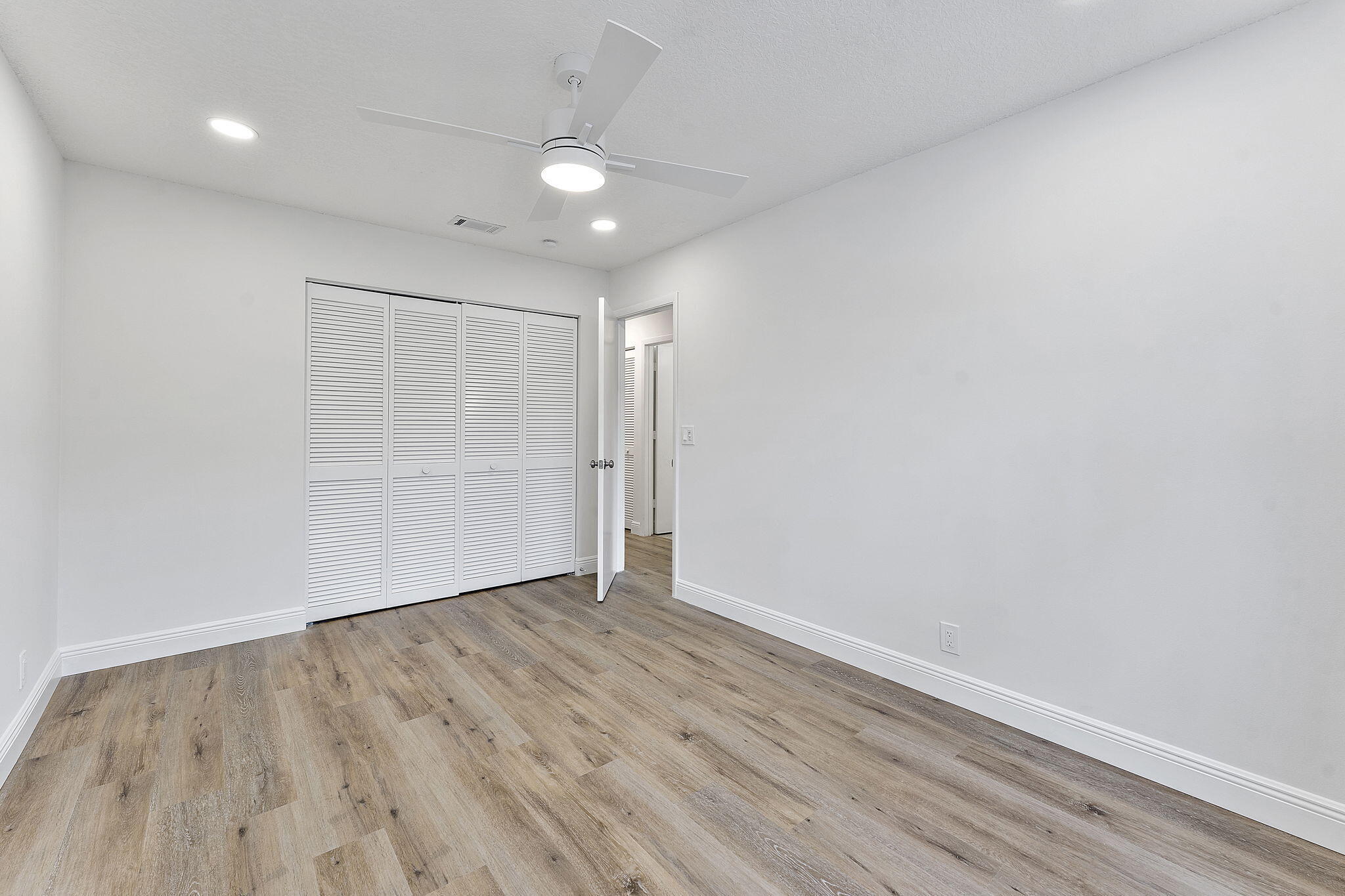 9180 Pine Springs Drive Boca Raton, FL 33428 - Photo 20 of 29 a view of an empty room with wooden floor