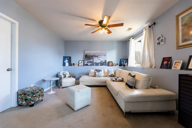 a living room with furniture and a walk in closet